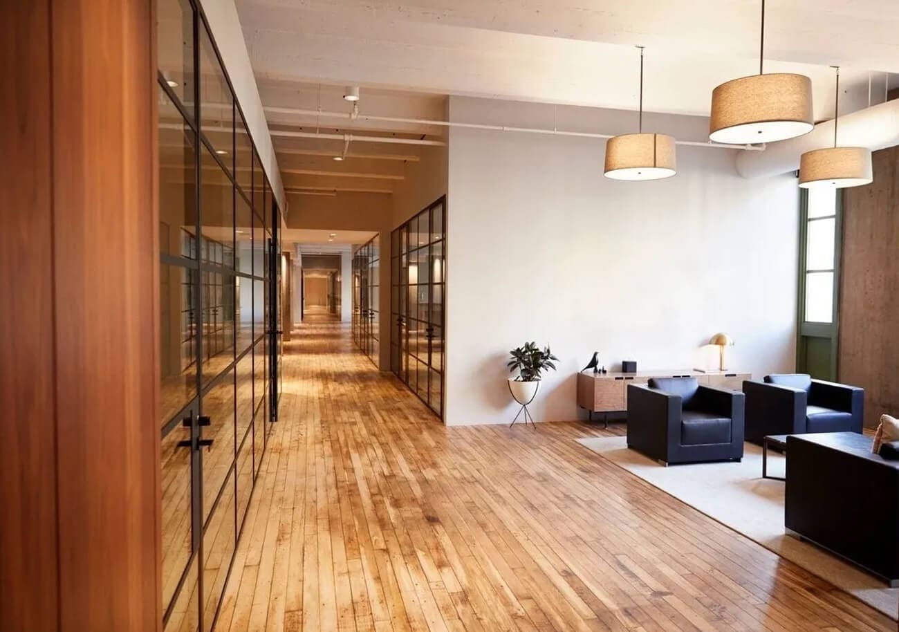 A room with wood floors and glass walls.