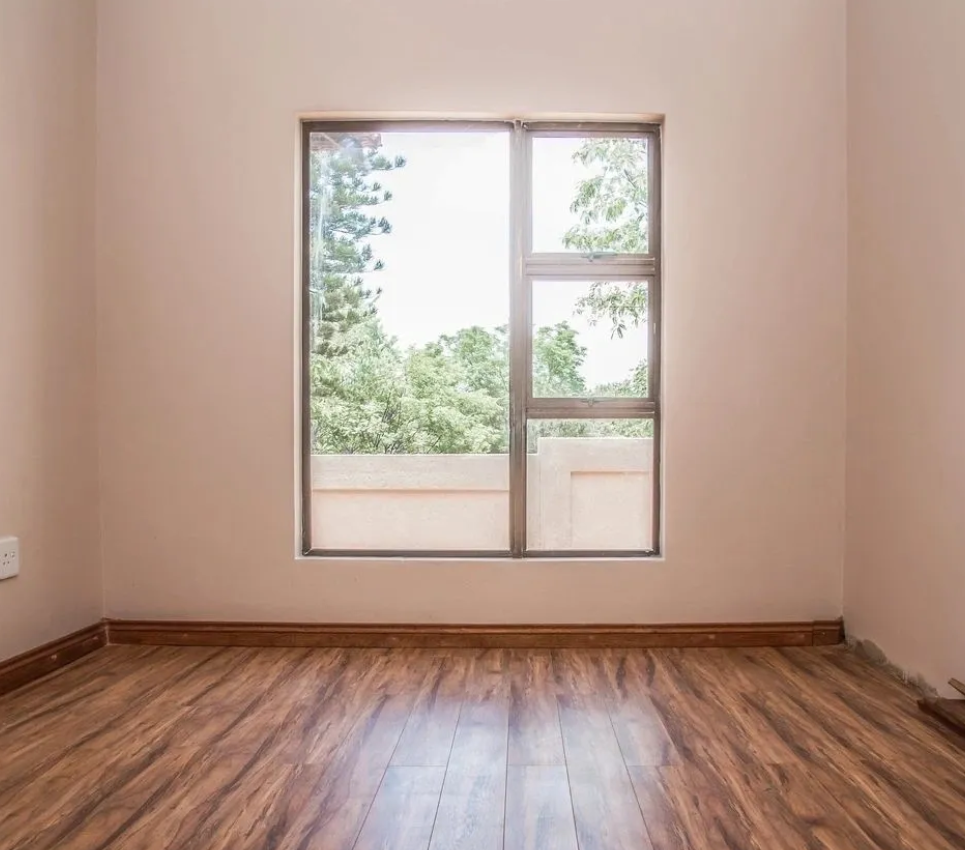 A room with a window and wooden floors