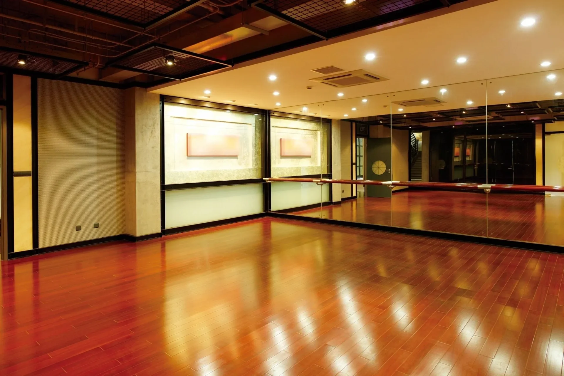 A dance studio with mirrors and wooden floors