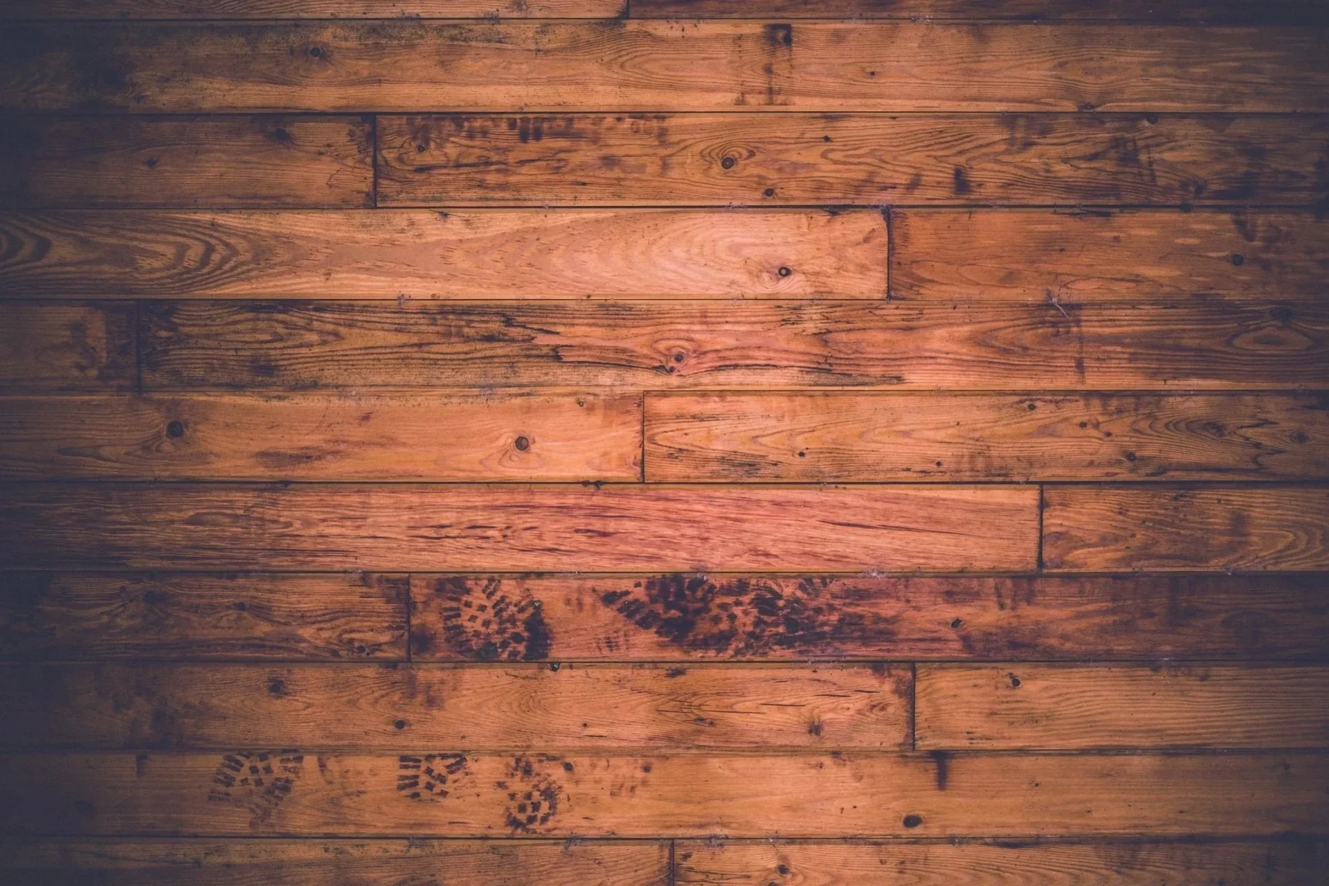 A wooden floor with some brown wood planks